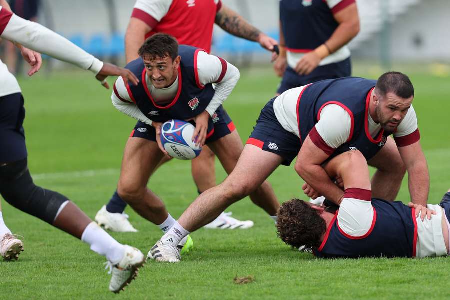 England's scrum-half Alex Mitchell (L) retrieves the ball from a ruck during a training session