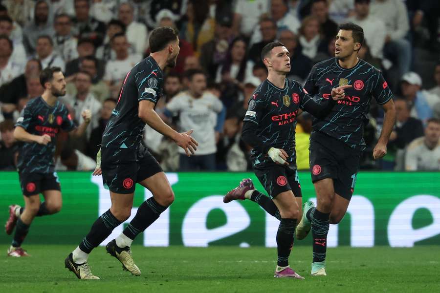 Phil Foden (2nd R) celebrates with teammates after scoring his team's second goal during the UEFA Champions League quarter final first leg football match between Real Madrid CF and Manchester City