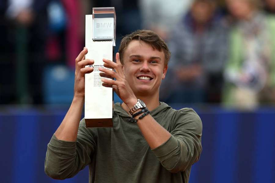 Holger Rune holds up the trophy after beating Botic van de Zandschulp in the ATP Munich final