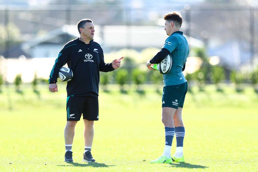 All Blacks assistant coach Jason Holland speaks with Beauden Barrett at a training session.