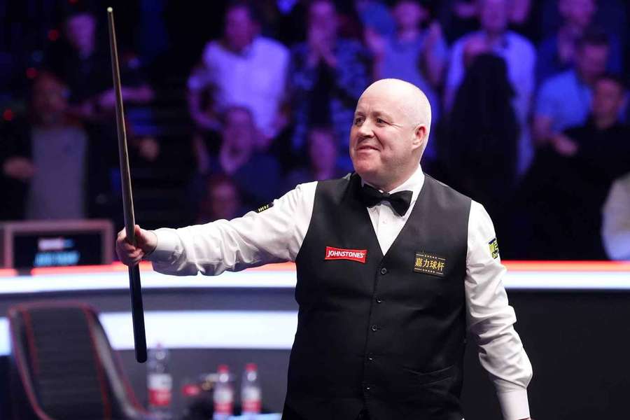 John Higgins celebrates his win against Judd Trump