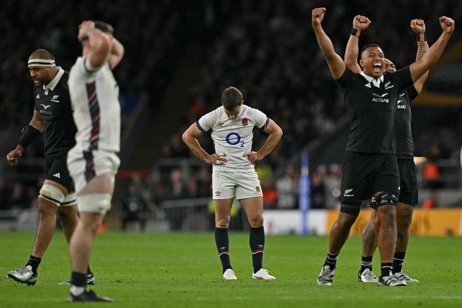 England's George Ford (C) reacts after missing a last second drop-goal handing the win to New Zealand