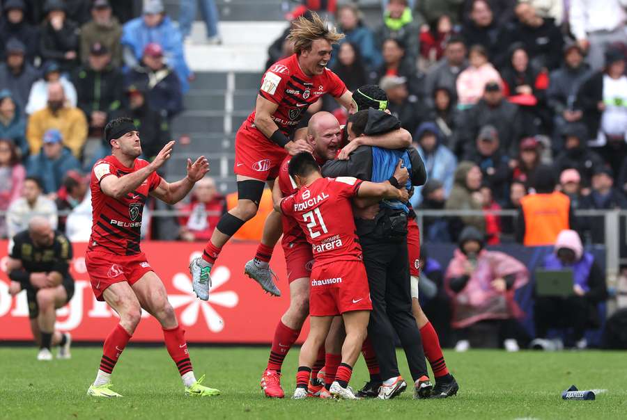 Thomas Ramos is swarmed by teammates after winning the game for Toulouse