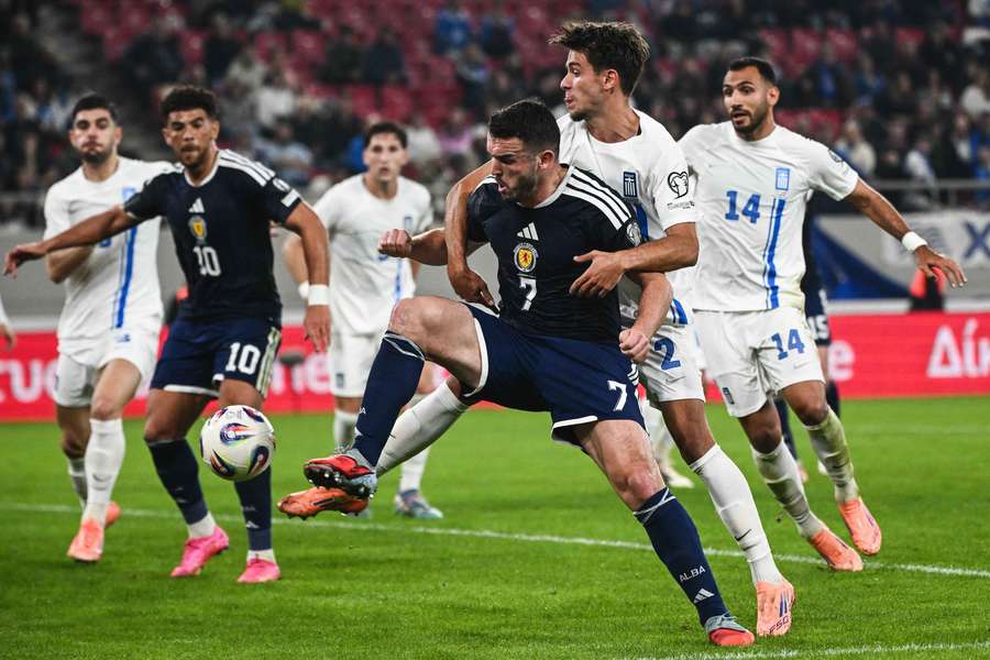 Scotland midfielder John McGinn (C) and Greece defender Giorgios Vagiannidis fight for the ball Scotland midfielder John McGinn (C) and Greece defender Giorgios Vagiannidis fight for the ball
