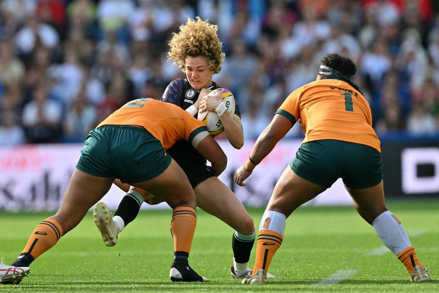 England full back Ellie Kildunne is tackled by Australia hooker Adiana Talakai in their Pool A clash on Saturday