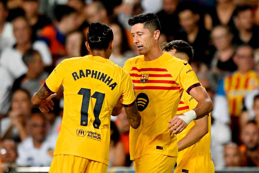 Robert Lewandowski (right) celebrates scoring his second goal