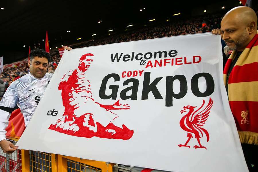 Liverpool fans hold up a welcoming banner at Anfield