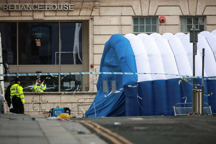 Police officers patrol the crime scene