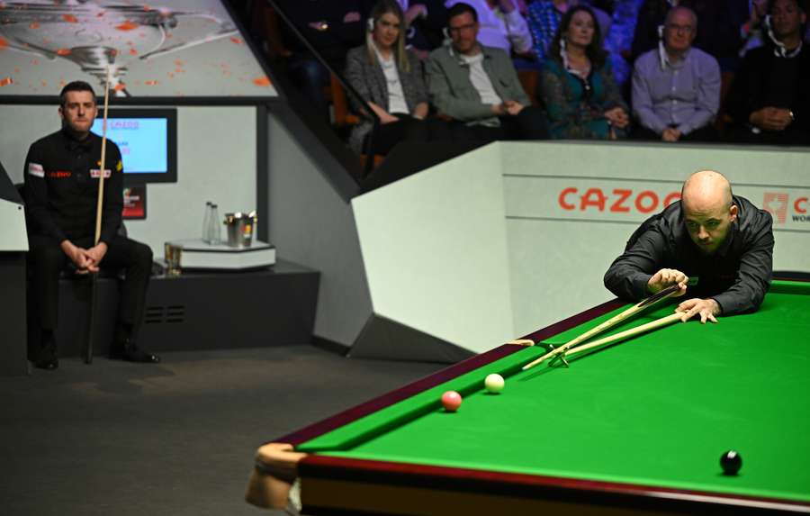 England's Mark Selby (L) looks on as Belgium's Luca Brecel plays a shot