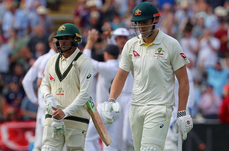 Australia's Cameron Green (R) walks back to the pavilion after losing his wicket for 29