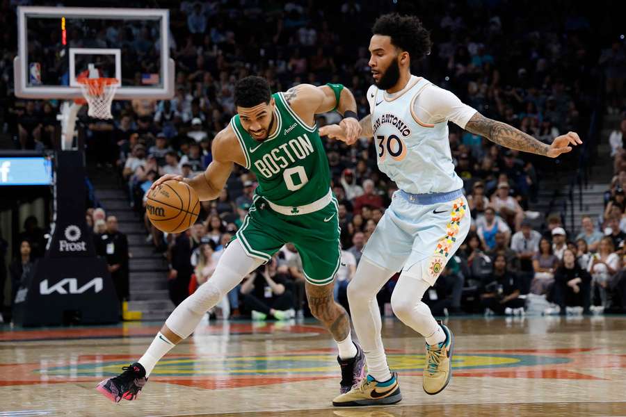 Jayson Tatum of the Boston Celtics drives on Julian Champagnie of the San Antonio Spurs