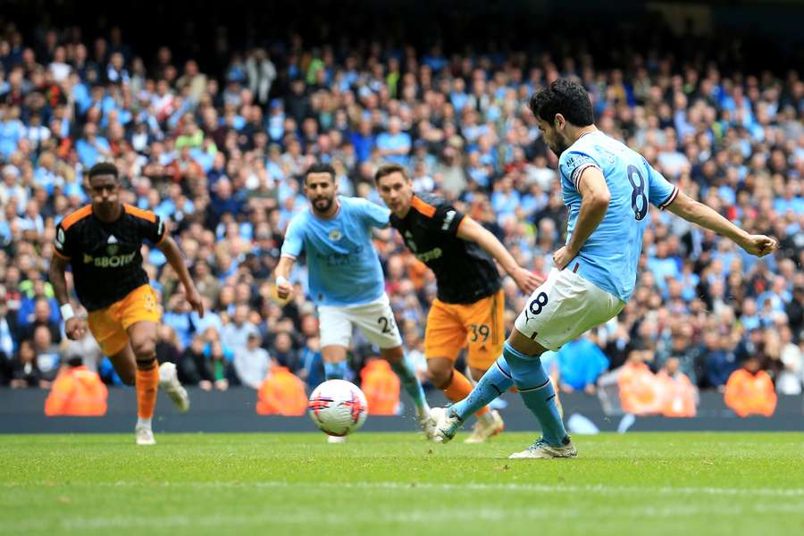 Manchester City midfielder Ilkay Gundogan (R) kicks and misses a penalty