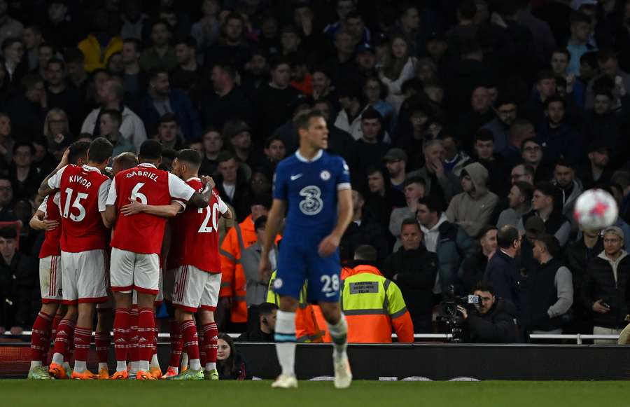 Chelsea's Spanish defender Cesar Azpilicueta (C) reacts as Arsenal's Norwegian midfielder Martin Odegaard is mobbed by teammates after scoring the team's second goal