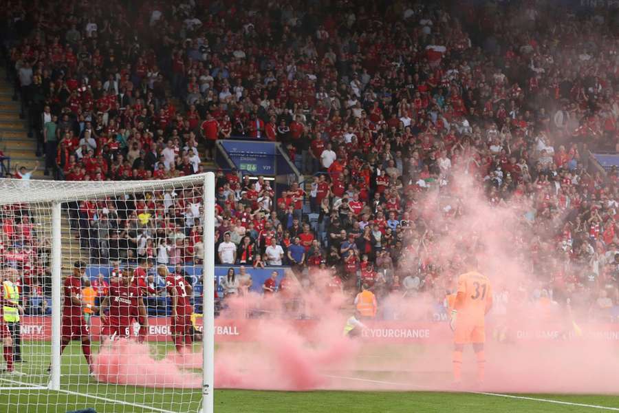  Flares are thrown onto the pitch by Liverpool fans during the The FA Community Shield