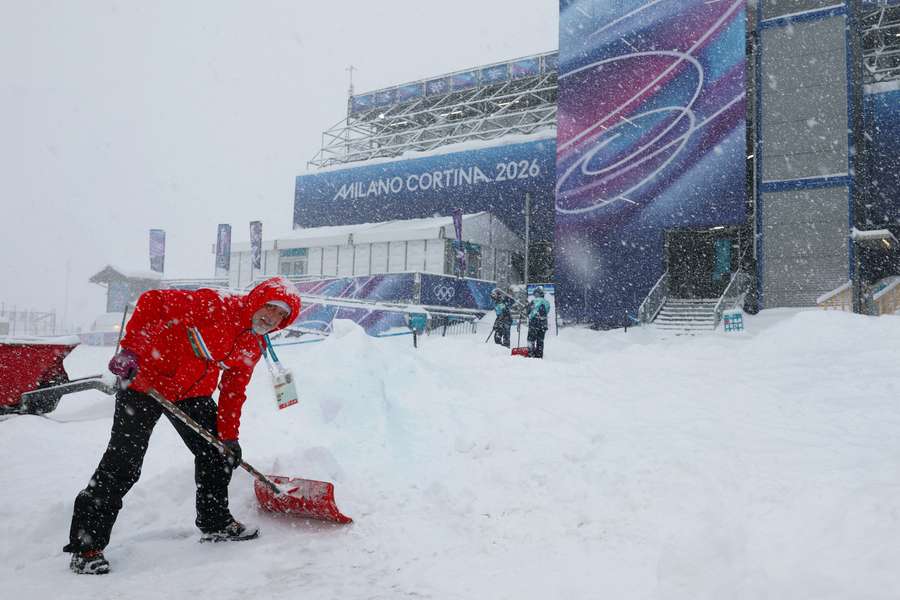 Workers attend to the course after the men's freeski halfpipe and aerials qualification was postponed due to weather conditions