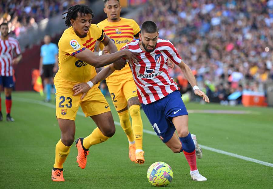 Barcelona's Jules Kounde vies with Atletico's Yannick Ferreira-Carrasco