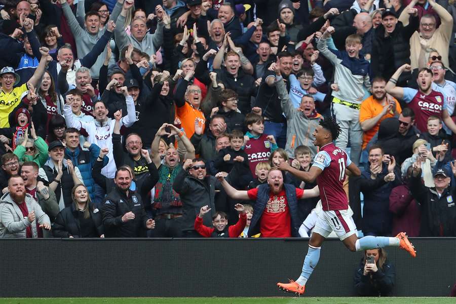 Aston Villa striker Ollie Watkins celebrates in front of fans after scoring their third goal