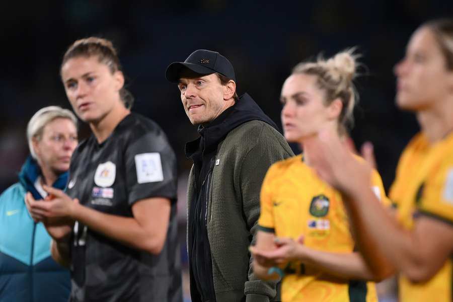 Australia coach Tony Gustavsson and his players react after losing the World Cup semi-final against England