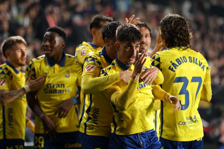 Manu Fuster of Las Palmas celebrates with teammates after scoring the team's third goal