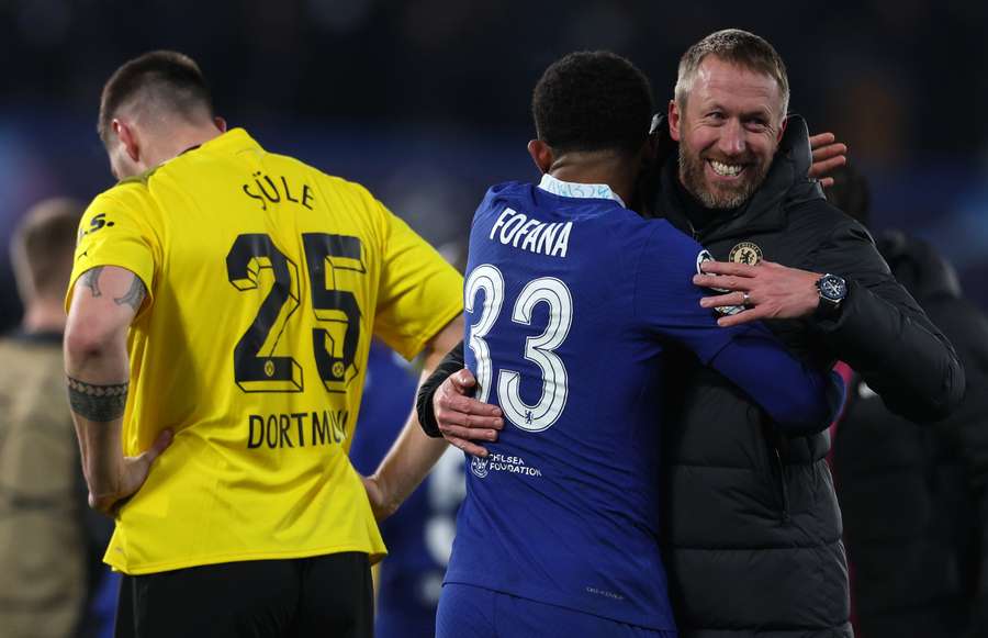 Graham Potter celebrates with Chelsea's French defender Wesley Fofana after the UEFA Champions League round of 16 second-leg football match between Chelsea and Borussia Dortmund