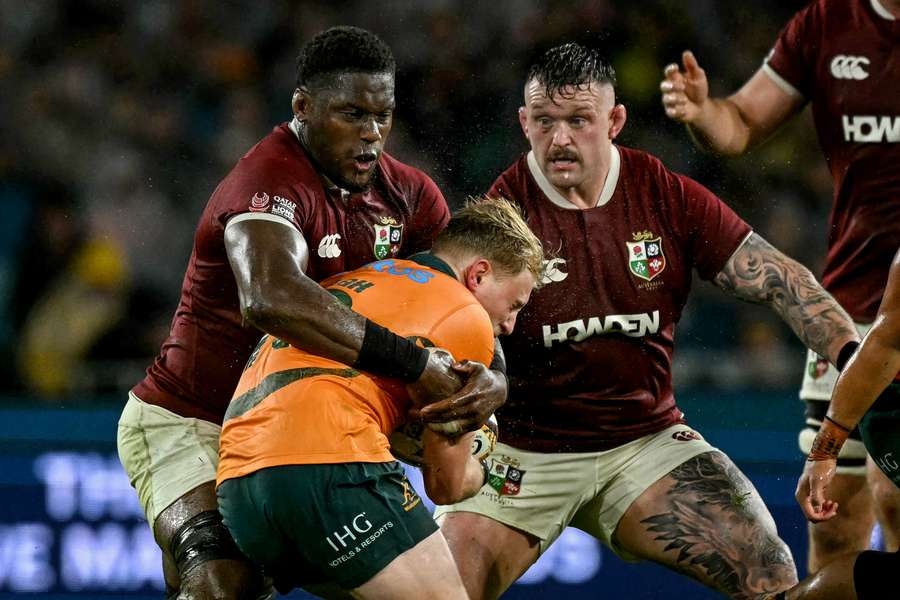 Tom Lynagh receives a hard tackle in the third Test against the British & Irish Lions.