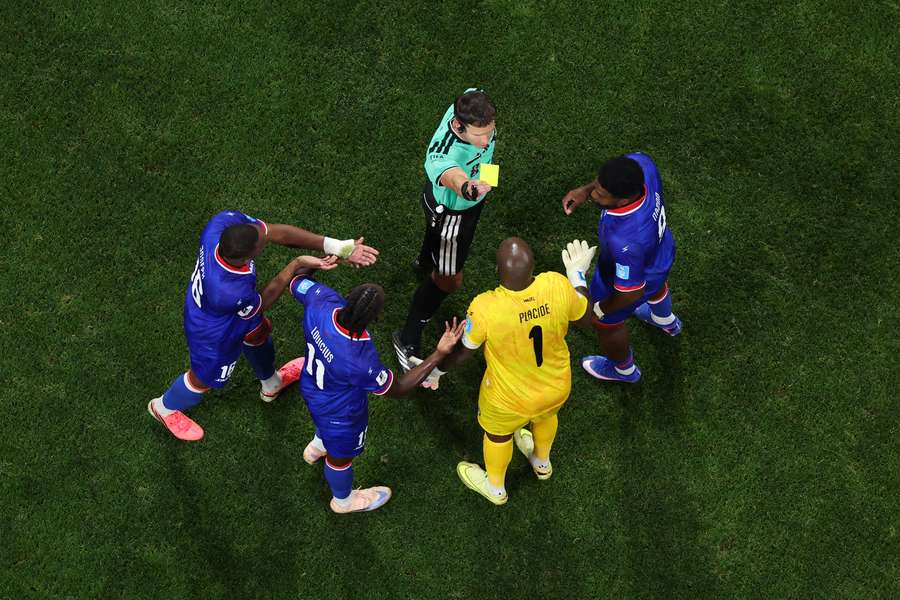 Referee Danny Makkelie shows Haiti goalkeeper Johnny Placide a yellow card agains Morocco Referee Danny Makkelie shows Haiti goalkeeper Johnny Placide a yellow card agains Morocco