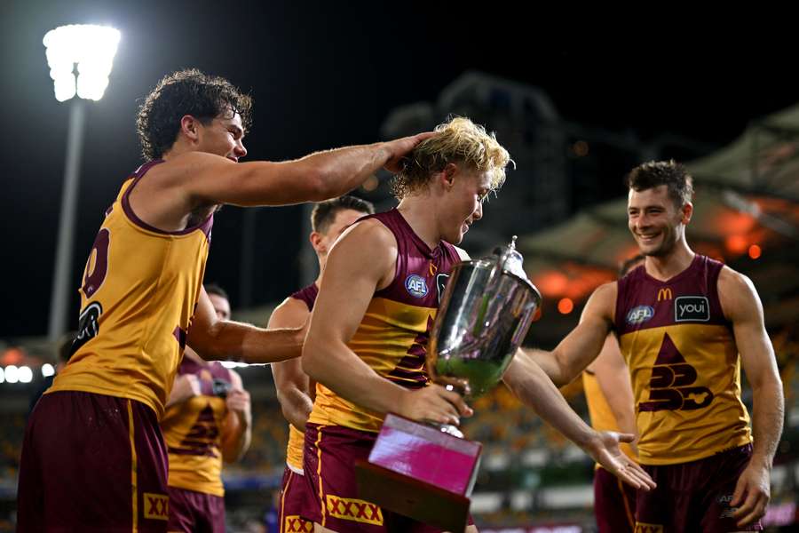 Levi Ashcroft and his Brisbane Lions teammates celebrate another Q-Clash victory. 
