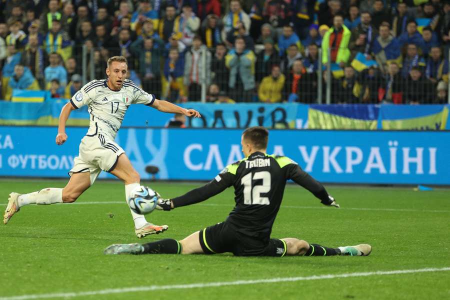 Italy midfielder Davide Frattesi sees his shot saved by Ukraine goalkeeper Anatoliy Trubin