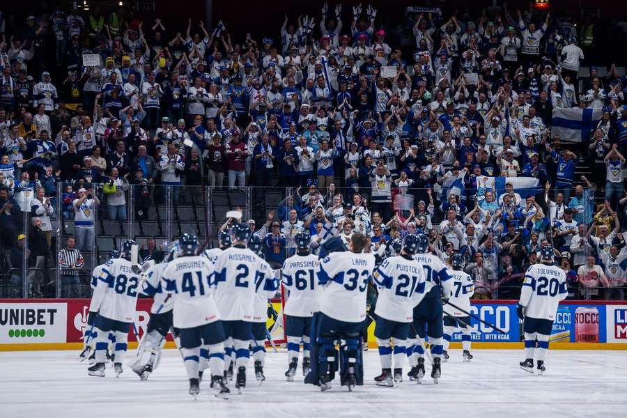 Finland's players celebrate with their fans after the shootout Finland's players celebrate with their fans after the shootout