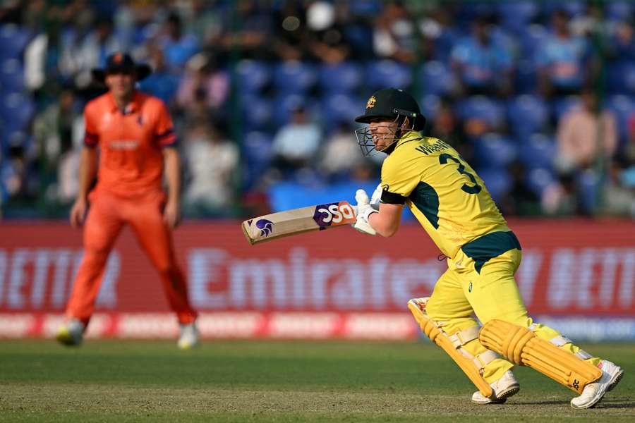 Australia's David Warner watches the ball after playing a shot