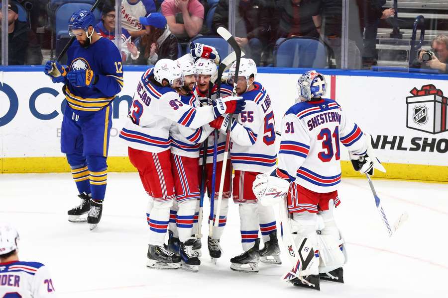 New York Rangers' Adam Fox celebrates his empty-net goal with teammates