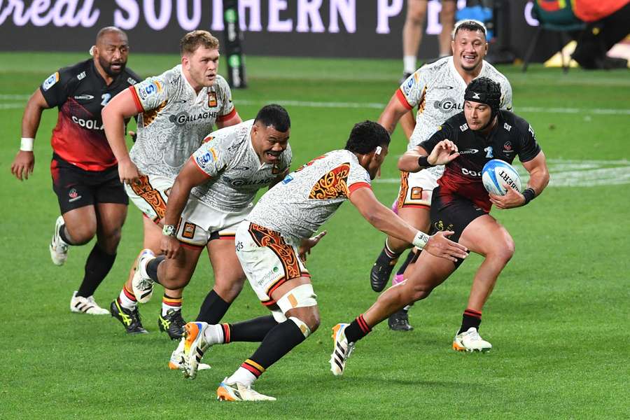 Crusaders winger Will Jordan attempts to evade three opponents on Friday night. 