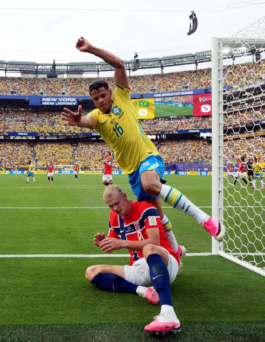 Norway's Erling Haaland and Brazil's Douglas Santos tumble off the pitch