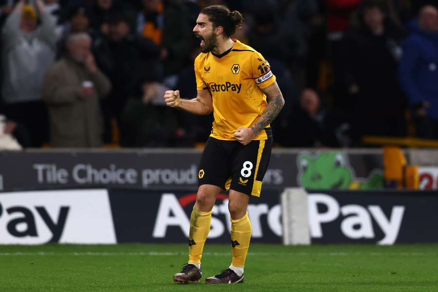 Wolves' Ruben Neves celebrates after scoring his team's third goal against Liverpool