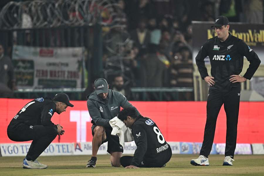 Rachin Ravindra receives treatment after getting hit in the face with ball.