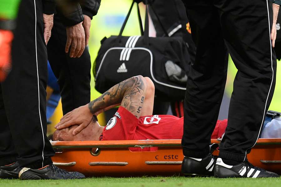 Man Utd's Brazilian midfielder Antony reacts as he is taken off on a stretcher against Chelsea