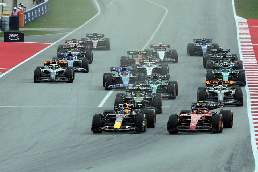 Red Bull driver Max Verstappen (C) and Ferrari driver Carlos Sainz Jr (R) lead the race at the start of the Spanish Grand Prix
