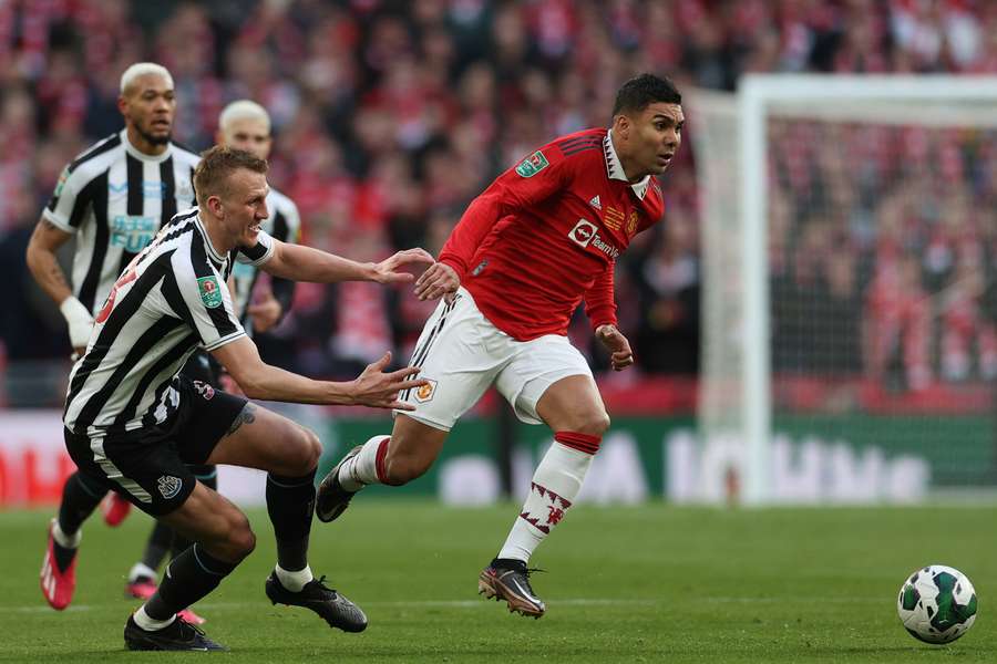 Manchester United's Brazilian midfielder Casemiro runs away from Newcastle United's English defender Dan Burn