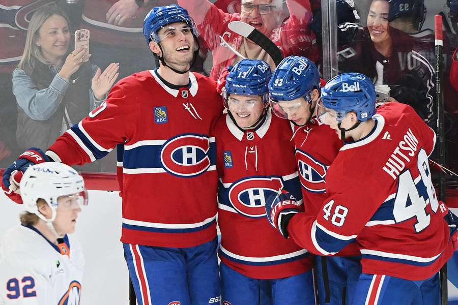 Cole Caufield (second from left) celebrates hat trick against the Islanders with his teammates Cole Caufield (second from left) celebrates hat trick against the Islanders with his teammates