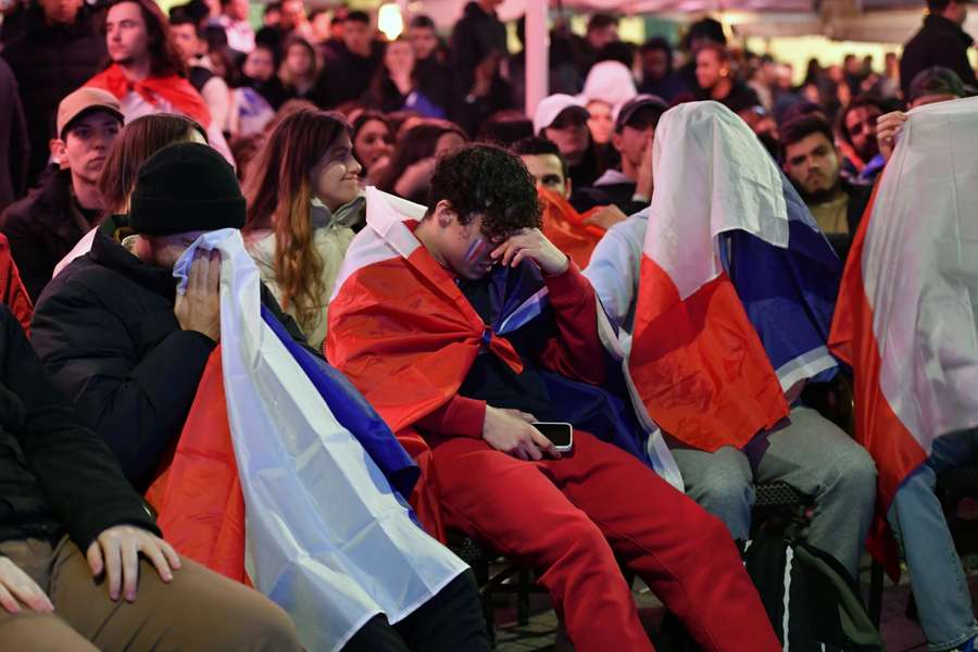 Fans react at the end of the World Cup final in a bar in Montpellier, France.