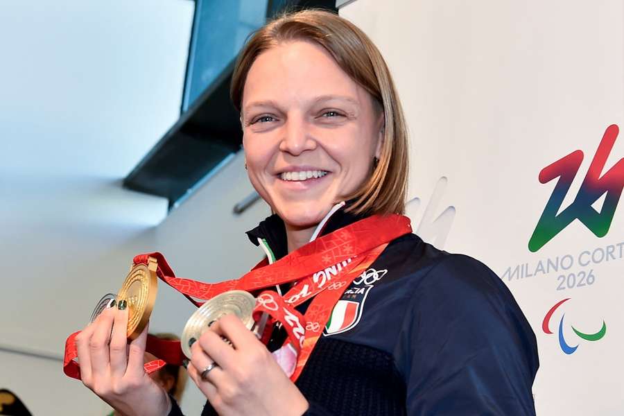 Arianna Fontana poses after disembarking with the Olympic delegation from an aircraft