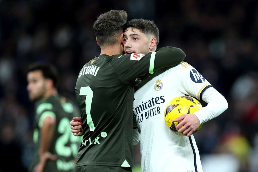 Real Madrid's Federico Valverde embraces Girona's Cristhian Stuani after the match