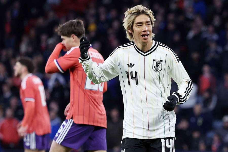Japan's Junya Ito celebrates scoring against Scotland Japan's Junya Ito celebrates scoring against Scotland
