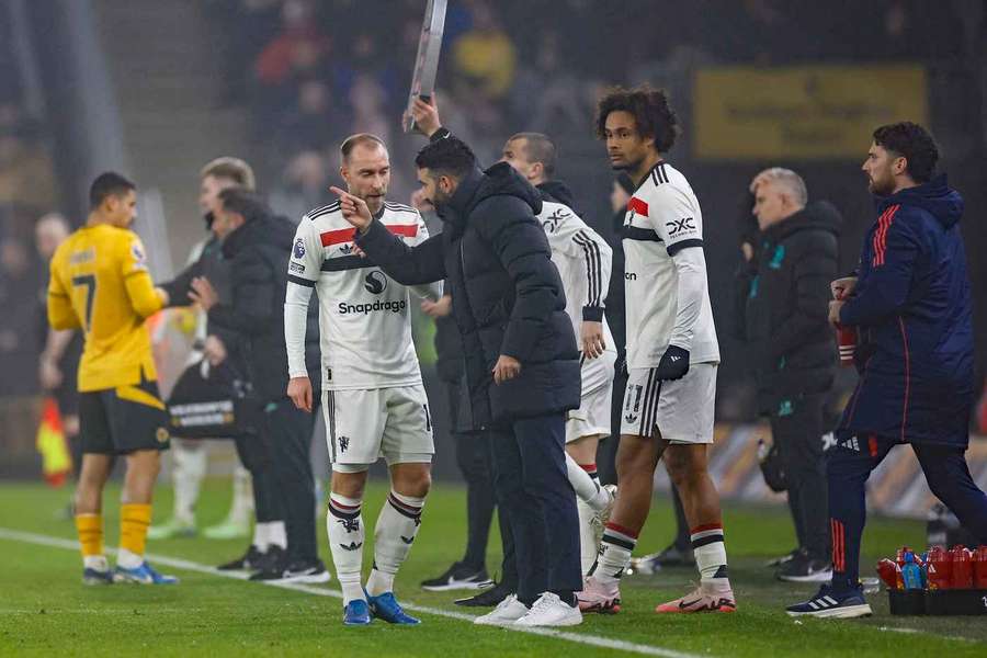 Manchester United manager Ruben Amorim gives instructions to Christian Eriksen during a game against Wolves