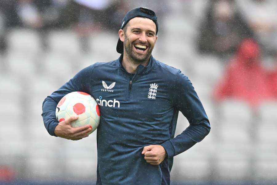 Mark Wood smiles in the rain