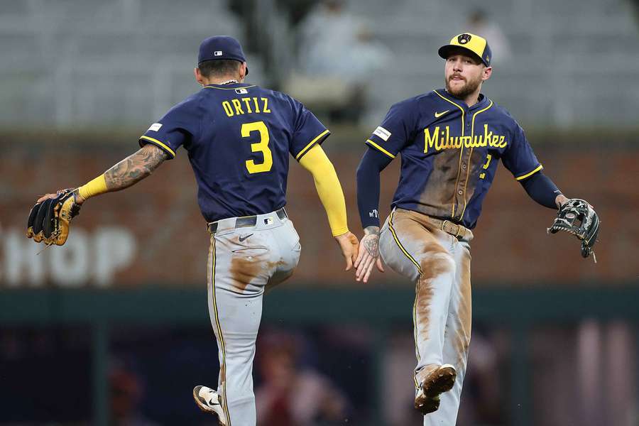 Joey Ortiz (left) and Brice Turang (right) celebrate after a win against the Atlanta Braves (2025)