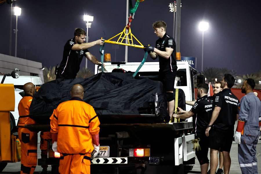 The car of Mercedes' George Russell is recovered back to the pits after stopping out on track