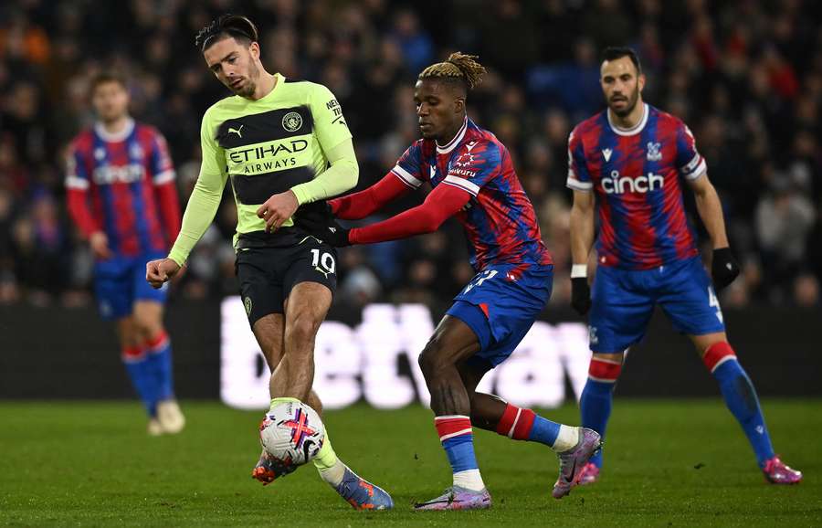 Wilfried Zaha vies with Manchester City's midfielder Jack Grealish