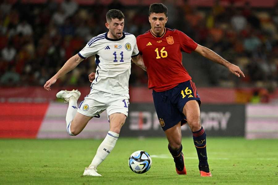 Rodri se bat pour le ballon avec Christie lors du match Espagne-Écosse à la Cartuja.