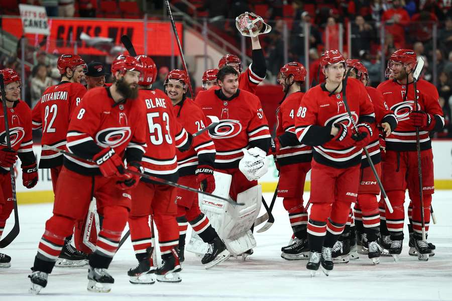 Hurricanes players celebrate on the ice after a win (2025)